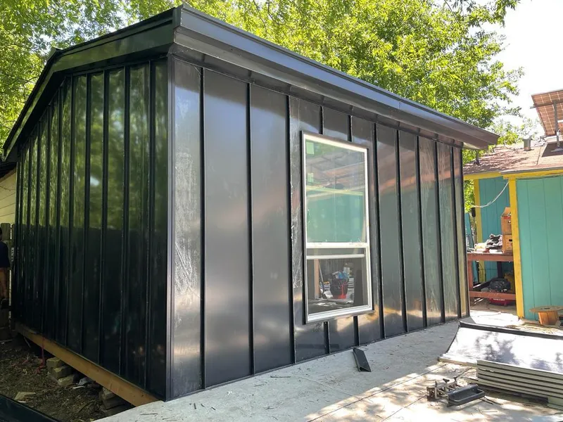 Black standing seam metal wall panels for Roof Inspection in Justin